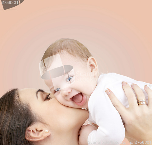 Image of laughing baby playing with mother