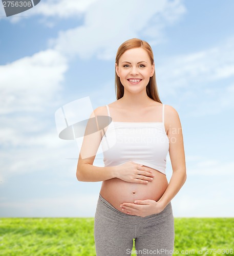 Image of happy future mother touching her belly