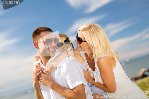 Image of happy family in sunglasses having fun outdoors