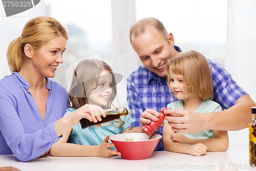 Image of happy family with two kids making dinner at home