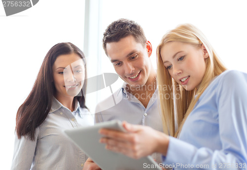 Image of business team working with tablet pc in office