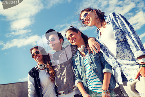 Image of smiling teenagers in sunglasses hanging outside