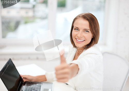 Image of businesswoman with laptop in office