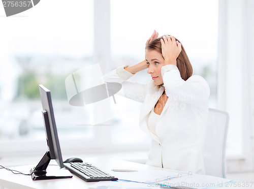 Image of stressed businesswoman with computer at work