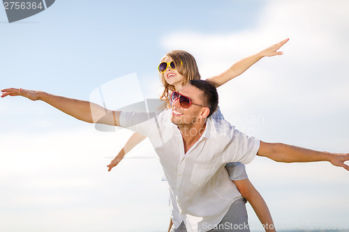 Image of happy father and child in sunglasses over blue sky
