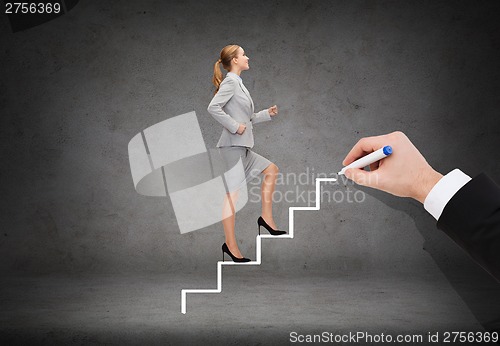 Image of smiling businesswoman stepping up staircase