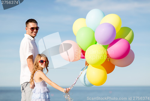 Image of happy father and daughter with colorful balloons