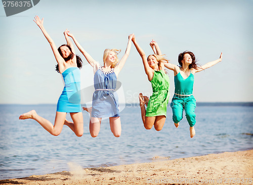 Image of girls jumping on the beach