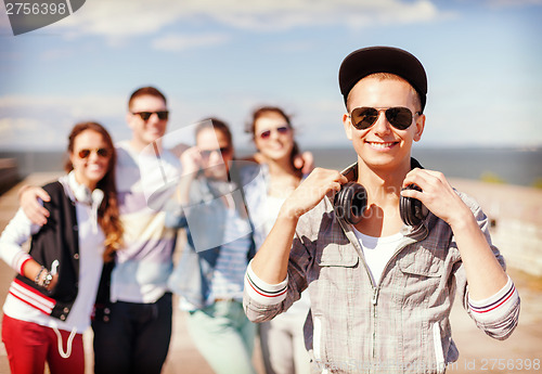 Image of teenage boy with sunglasses and friends outside