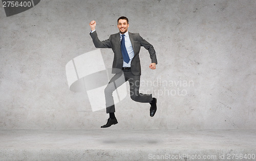 Image of smiling businessman jumping