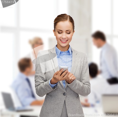 Image of young smiling businesswoman with smartphone