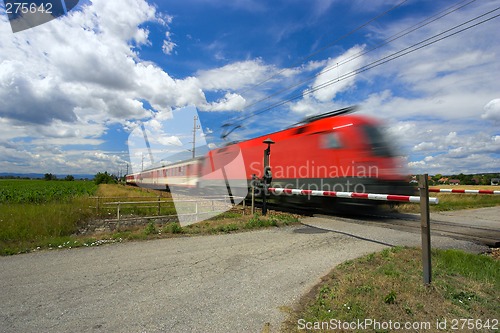 Image of Train passing through a railway crossing.