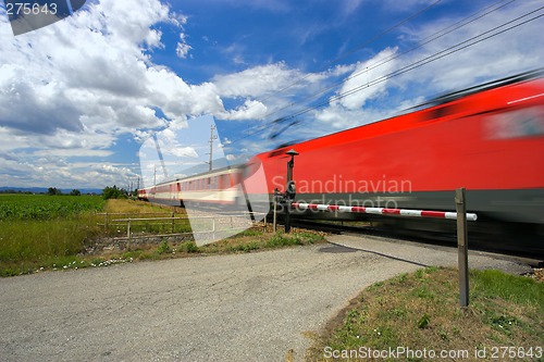 Image of Train passing through a railway crossing.