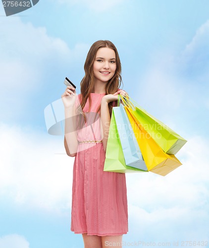 Image of smiling woman in dress with many shopping bags