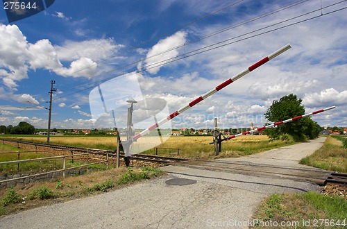 Image of Train passing through a railway crossing.