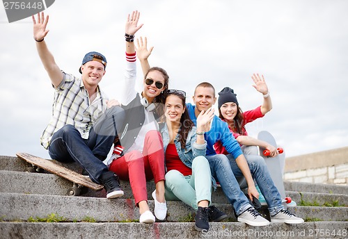 Image of group of smiling teenagers hanging out