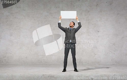 Image of smiling businessman with white blank board