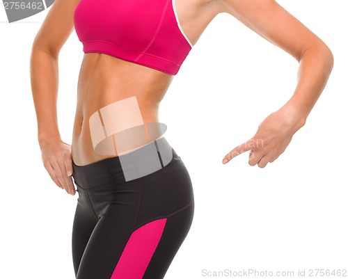 Image of close up of sporty woman pointing at her buttocks