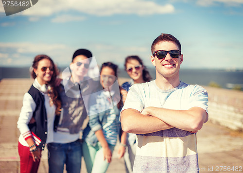 Image of teenage boy with sunglasses and friends outside