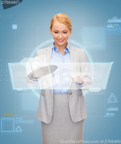 Image of smiling businesswoman working with virtual screen