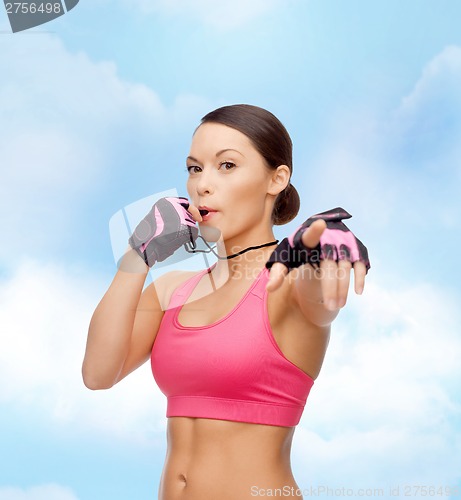 Image of asian personal trainer with whistle