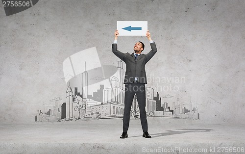 Image of smiling businessman with arrow on white board