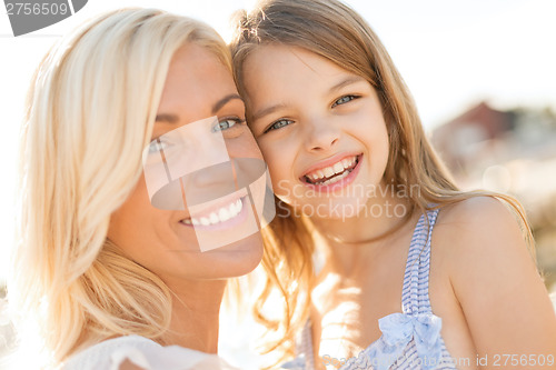 Image of happy mother and child girl outdoors