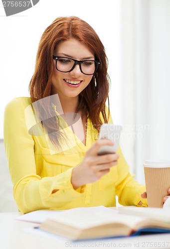 Image of smiling student girl with smartphone at school