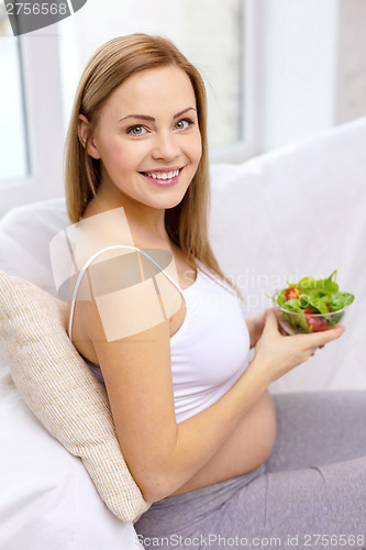 Image of happy pregnant woman with bowl of salad