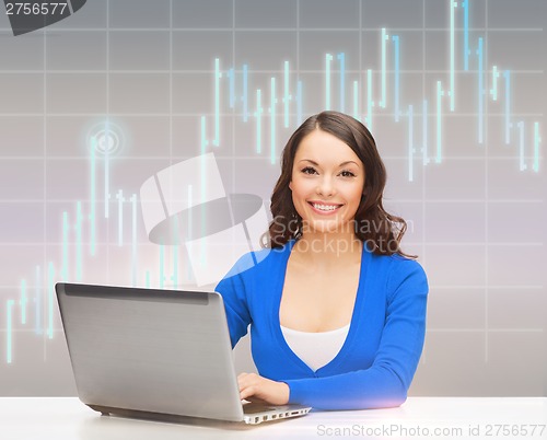 Image of smiling woman in blue clothes with laptop computer