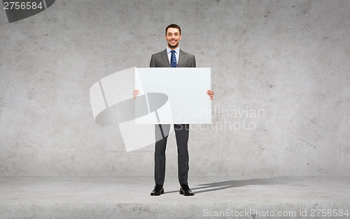 Image of smiling businessman with white blank board