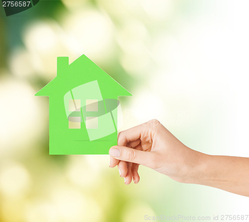 Image of hand holding green paper house