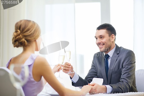 Image of couple with glasses of champagne at restaurant