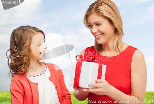 Image of smiling mother and daughter with gift box