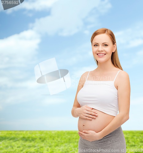 Image of happy future mother touching her belly