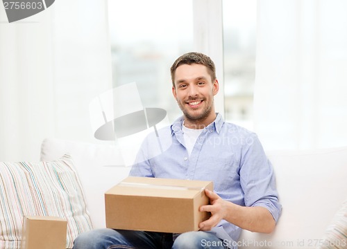 Image of man with cardboard boxes at home