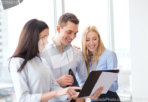 Image of business team looking at clipboard