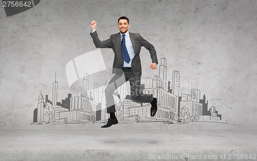 Image of smiling businessman jumping