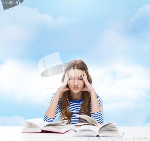 Image of stressed student girl with books