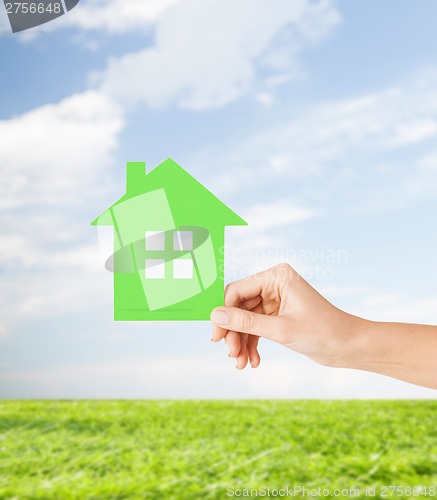 Image of hand holding green paper house