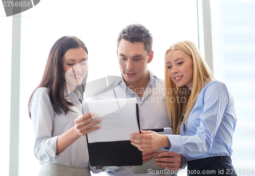 Image of business team looking at clipboard