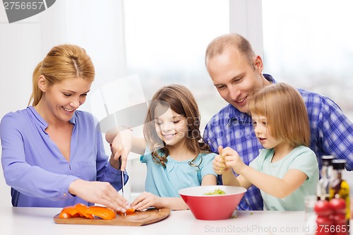 Image of happy family with two kids making dinner at home