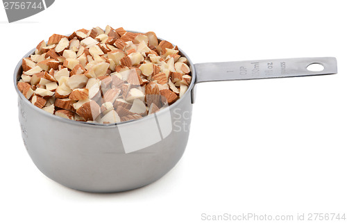 Image of Chopped almonds in a metal cup measure