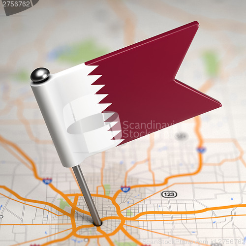 Image of Qatar Small Flag on a Map Background.