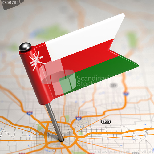Image of Oman - Small Flag on a Map Background.