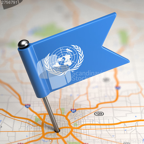 Image of United Nations Small Flag on a Map Background.