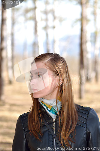 Image of Woman black leather jacket in the park