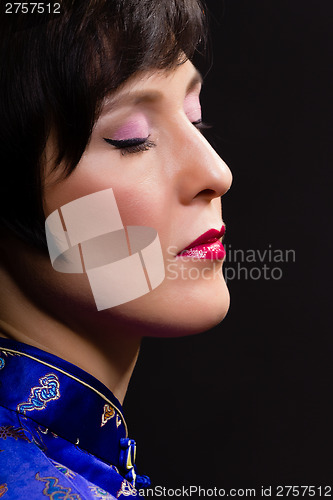 Image of Beautiful young woman. Japanese makeup. Portrait on black