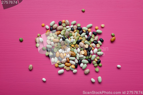 Image of Mixed dried beans and peas on a pink background