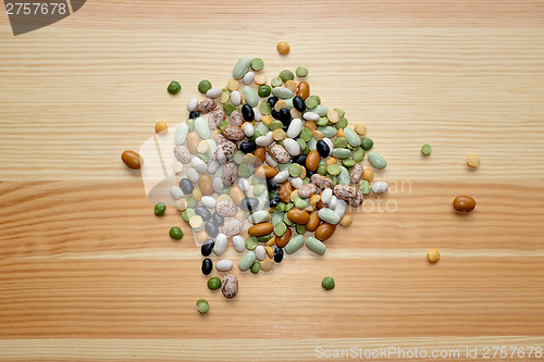 Image of Mixed dried beans and peas on a wooden background